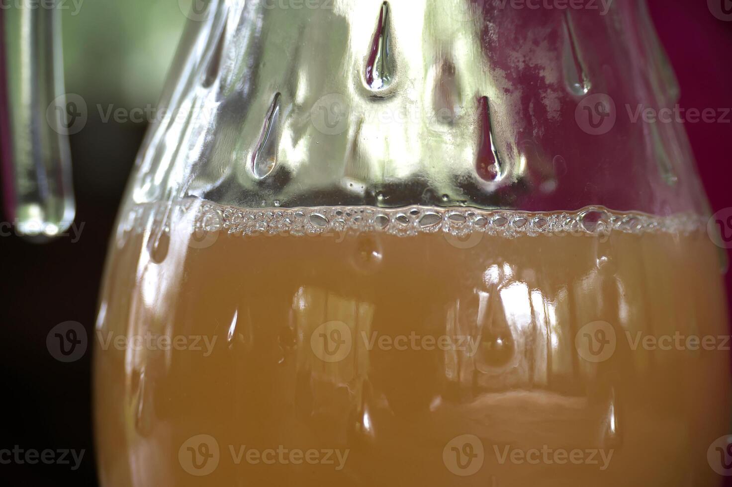 A close-up captures a glass filled with a refreshing beverage, showcasing condensation and bubbles. photo