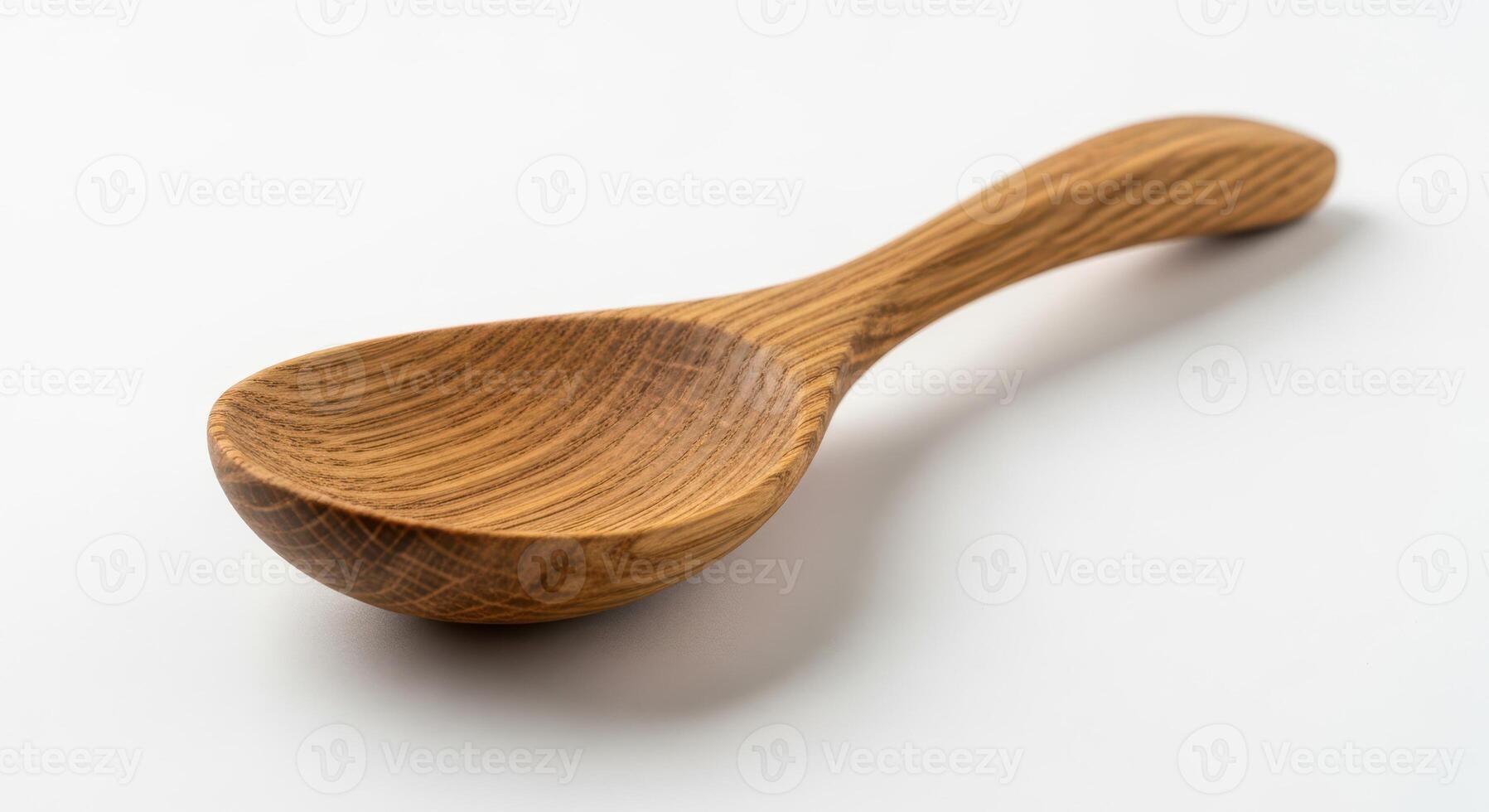 A simple wooden spoon isolated on a white background photo
