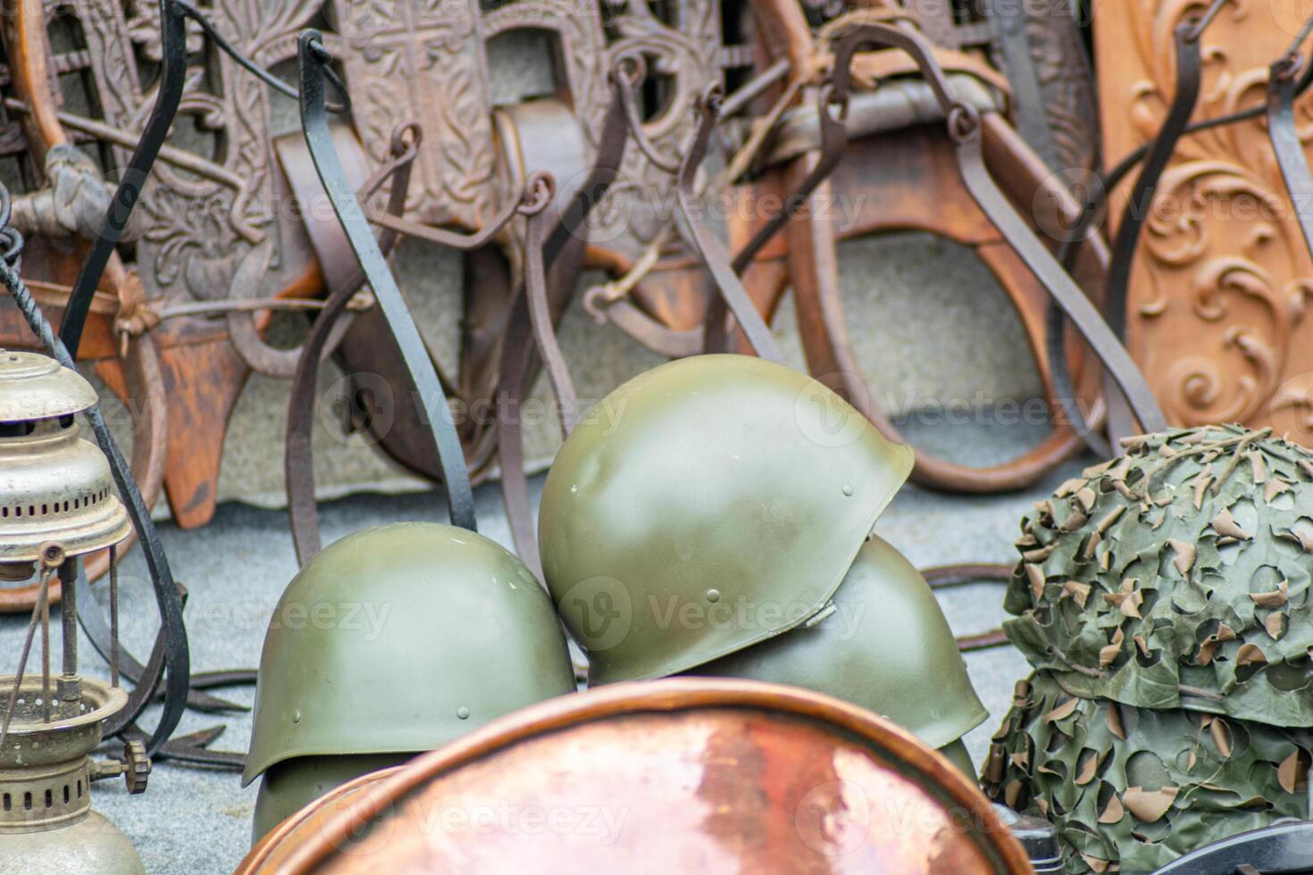 Antique war equipment and helmets from a past conflict. photo
