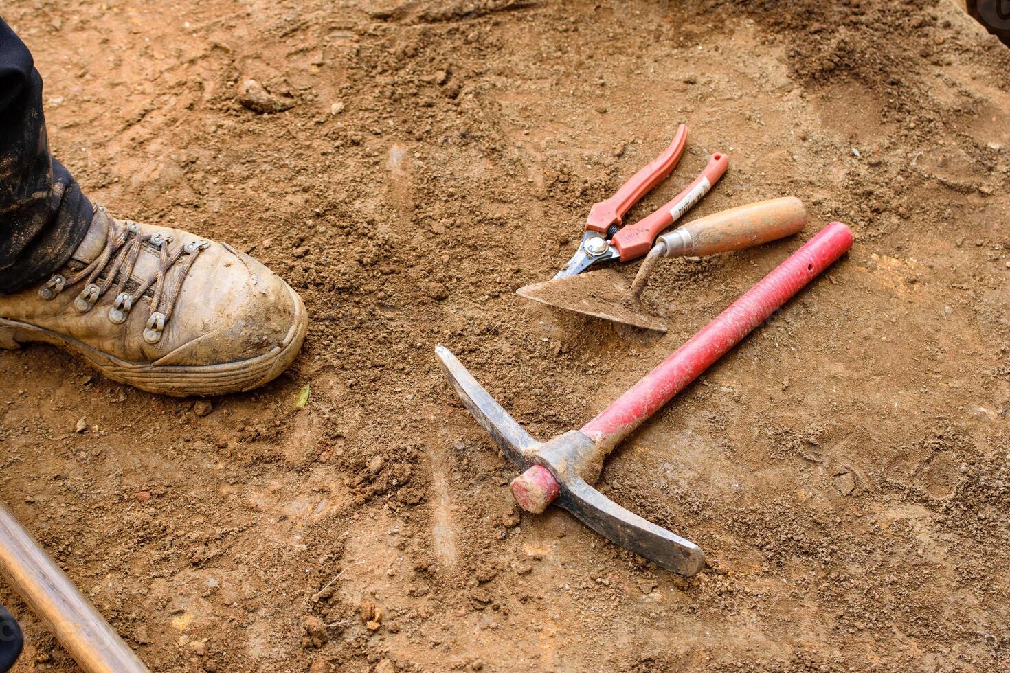 Work in Progress at an Excavation with a Muddy Boot photo