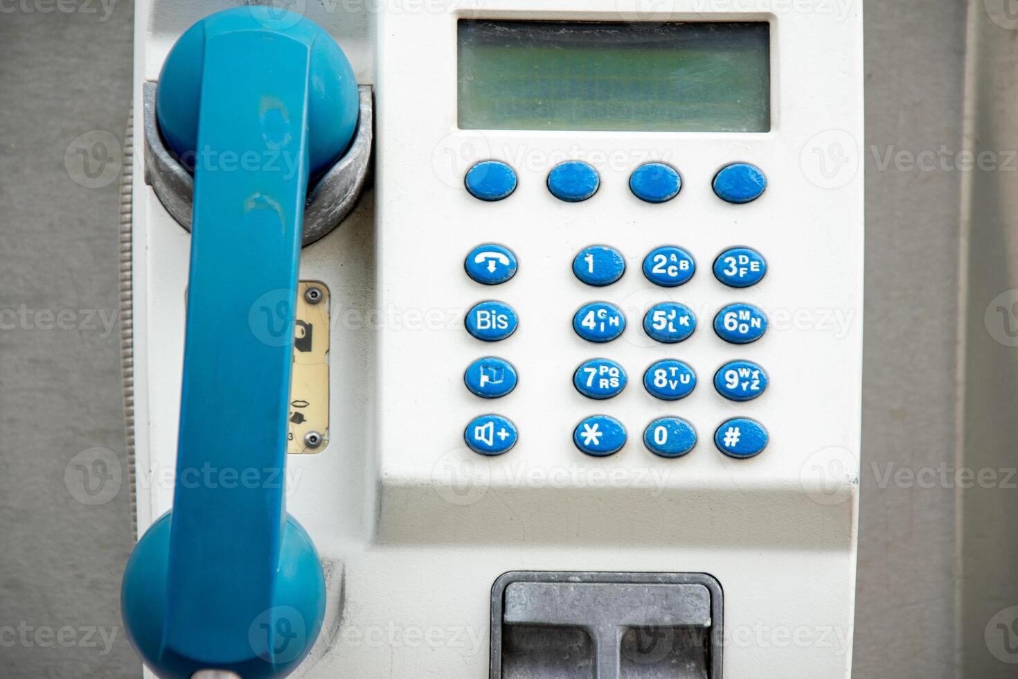 Retro style payphone with buttons and a digital screen. photo