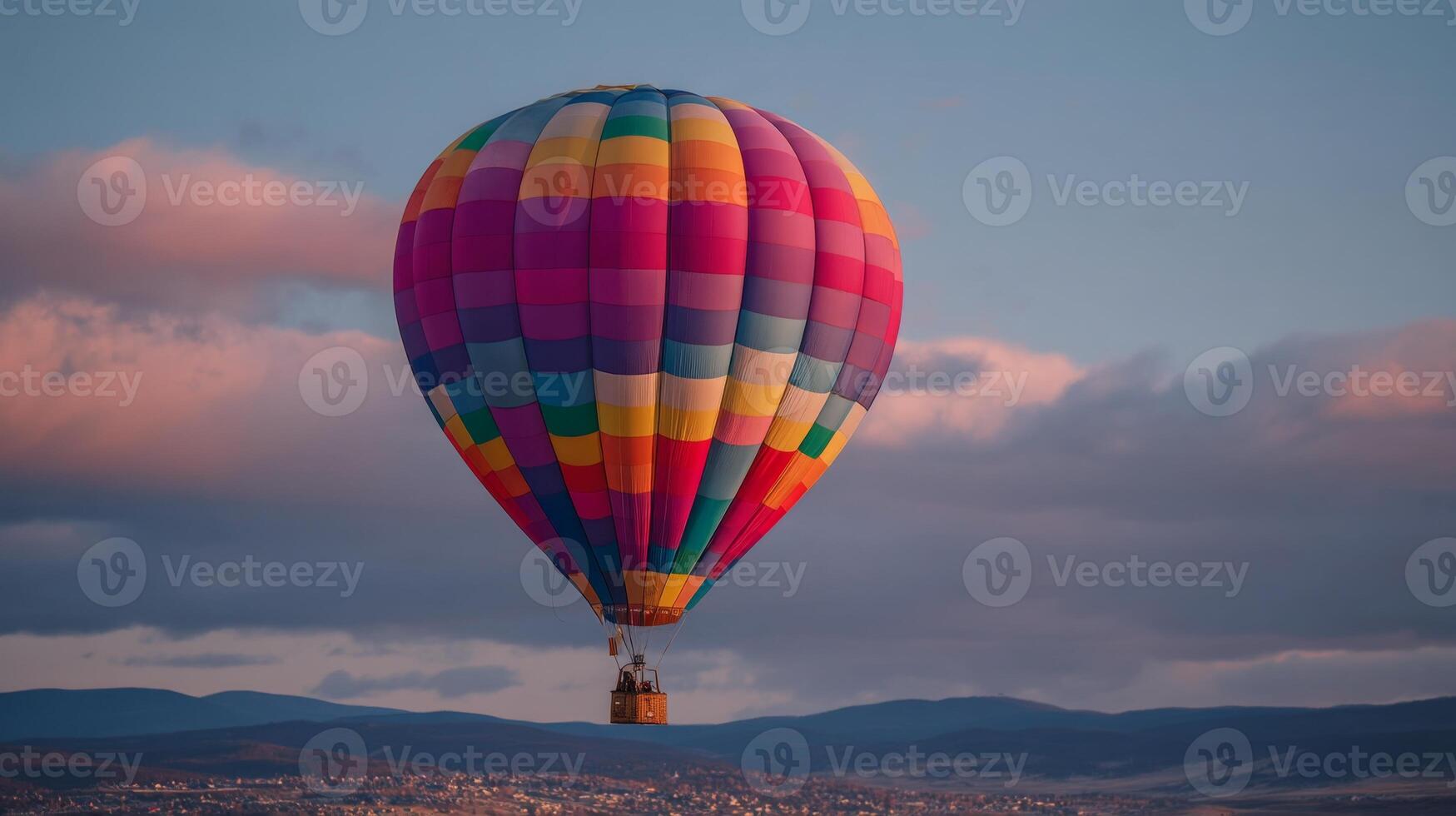 Colorful Hot Air Balloon Floating Above Mountains at Sunrise in a Clear Sky with Soft Clouds and a Peaceful Atmosphere photo