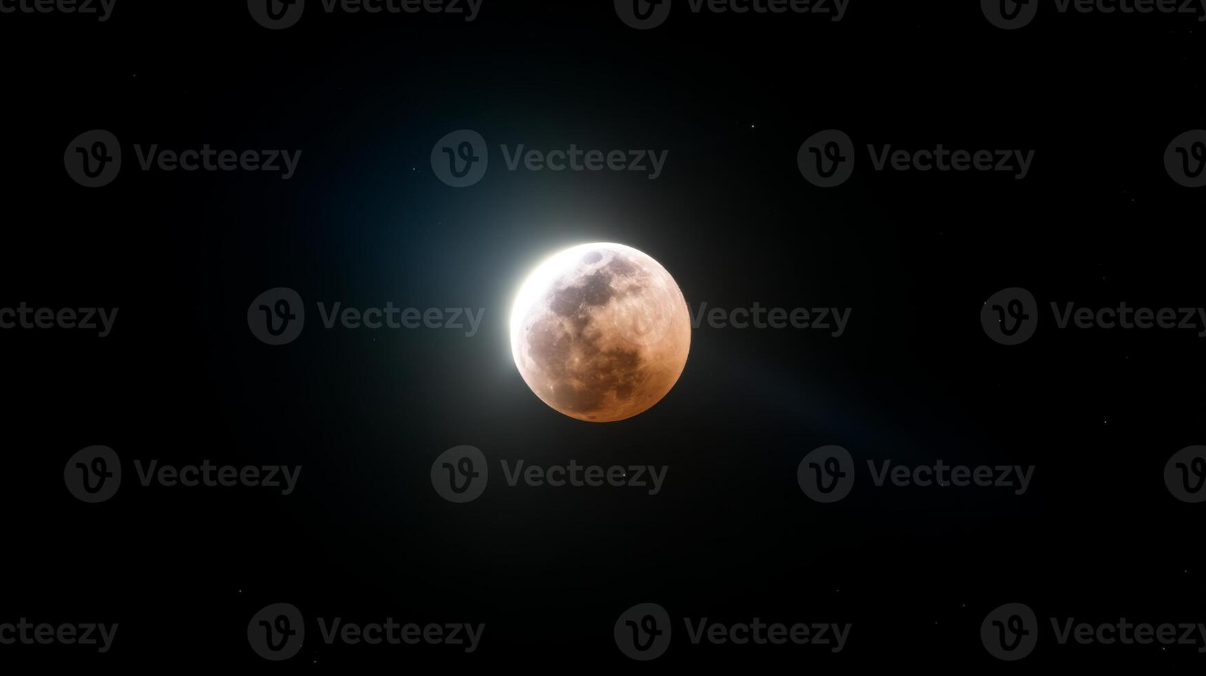 Stunning view of a lunar eclipse with shadow covering the moon and glowing light in the background, celestial event captured beautifully photo