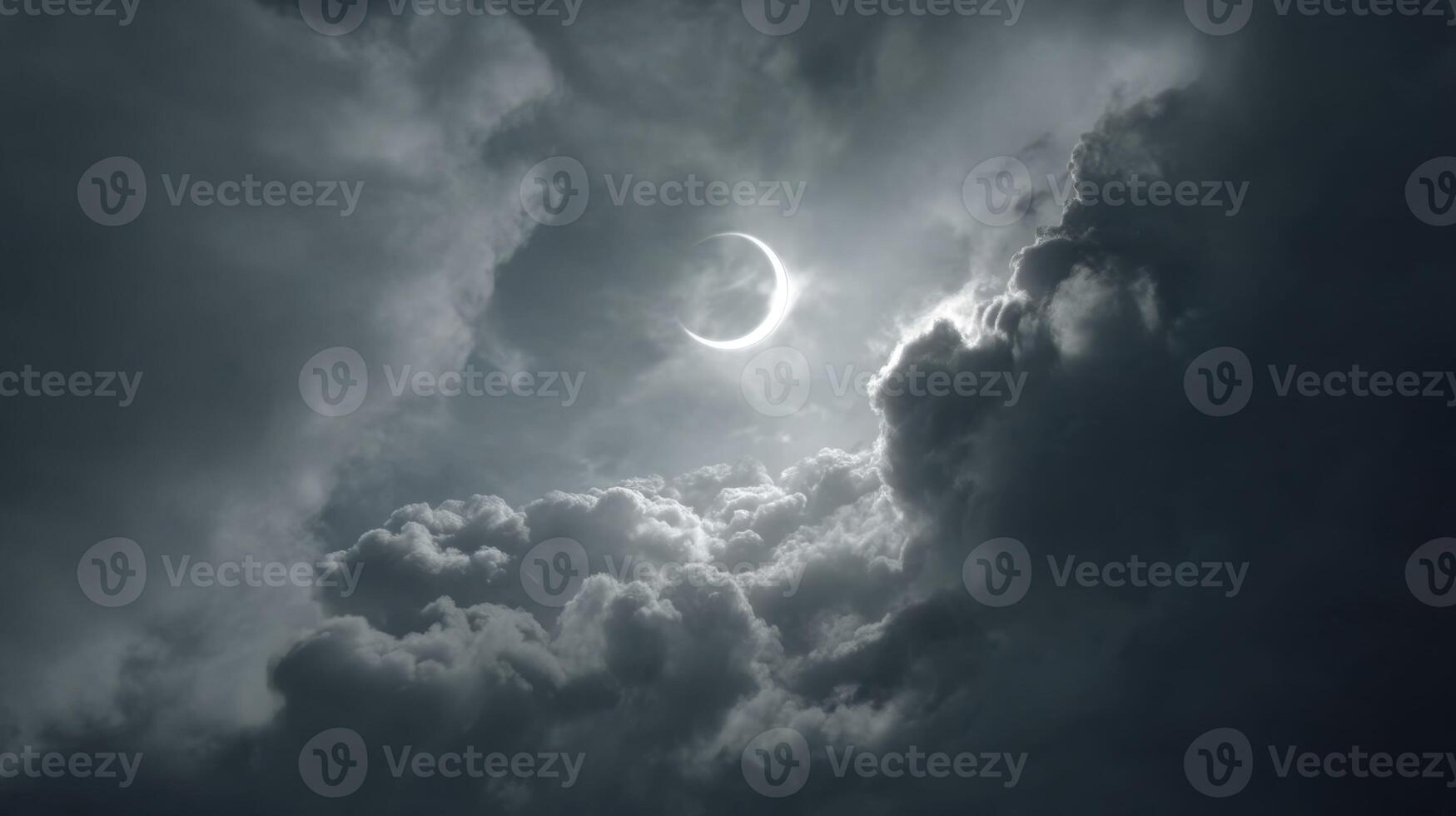 Dramatic Cloudy Sky with Crescent Moon Illuminated by Soft Light Amidst Dark Stormy Clouds at Twilight photo