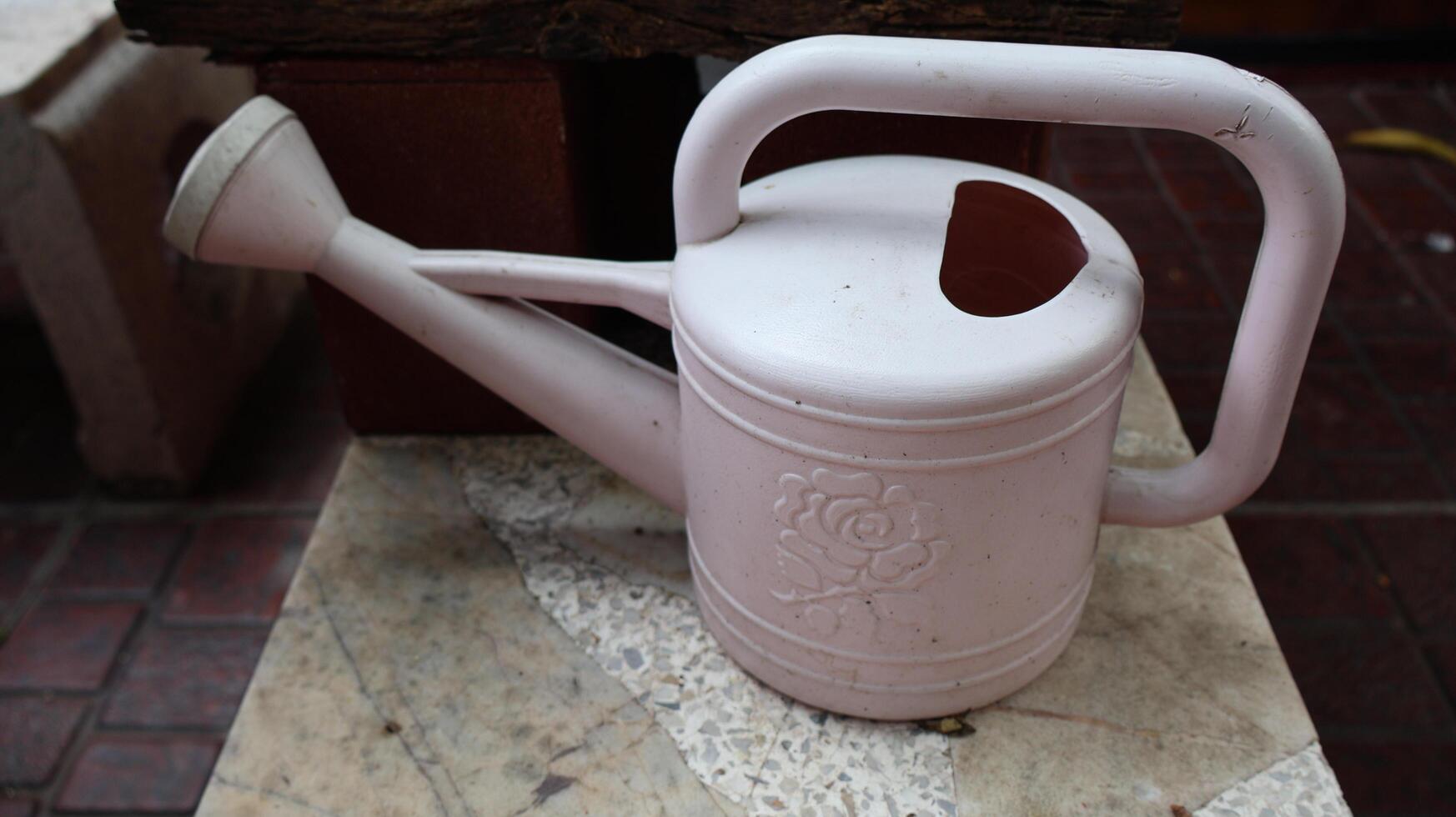 A watering can for plants in a home garden photo