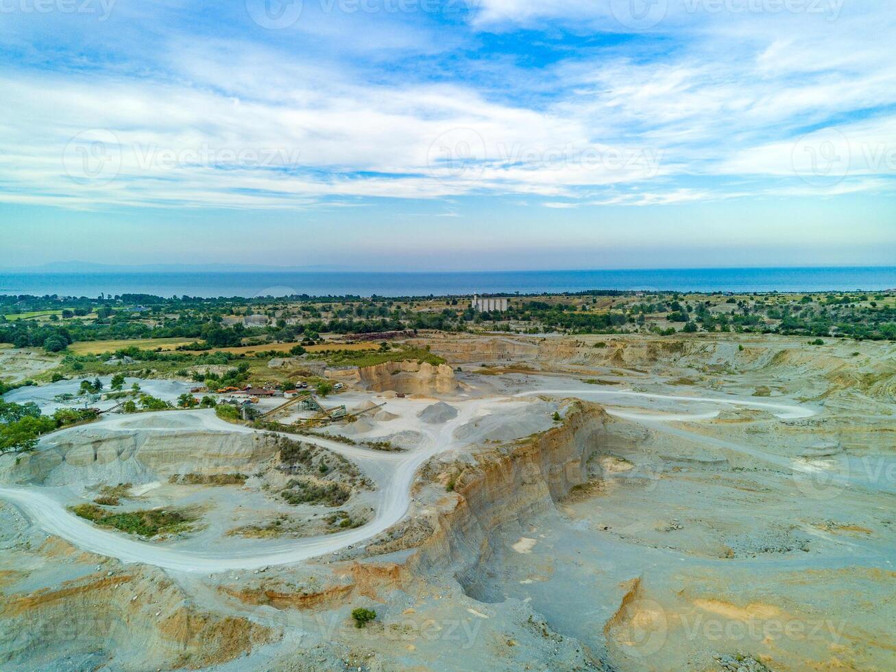 Sand craters in Montenegro and modern equipment and machines for the extraction of sand against the backdrop of mountains photo