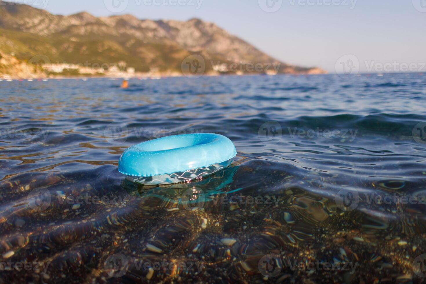 A blue rubber ring floats in the Adriatic SeaBlue rubber ring floats Adriatic SeaBlue rubber ring floats Adriatic SeaBlue rubber ring floats in Adriatic Sea photo