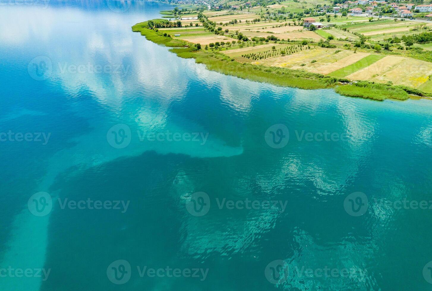 Fields planted with grain crops near Montenegrin villages on the coast of the Adriatic Sea against the backdrop of the Balkan Mountains and sky photo