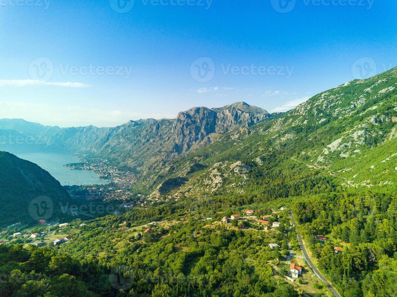 Bay of Kotor with beaches and hotels and the Adriatic Sea against the backdrop of sunny sky photo