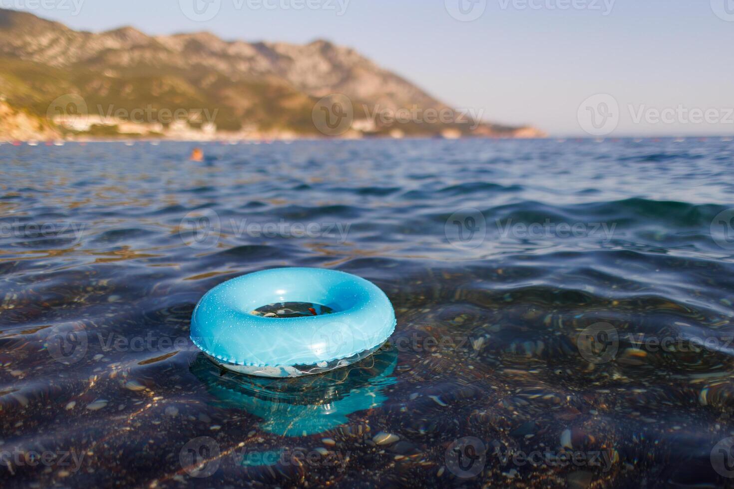 A blue rubber ring floats in the Adriatic SeaBlue rubber ring floats Adriatic SeaBlue rubber ring floats Adriatic SeaBlue rubber ring floats Adriatic Sea photo