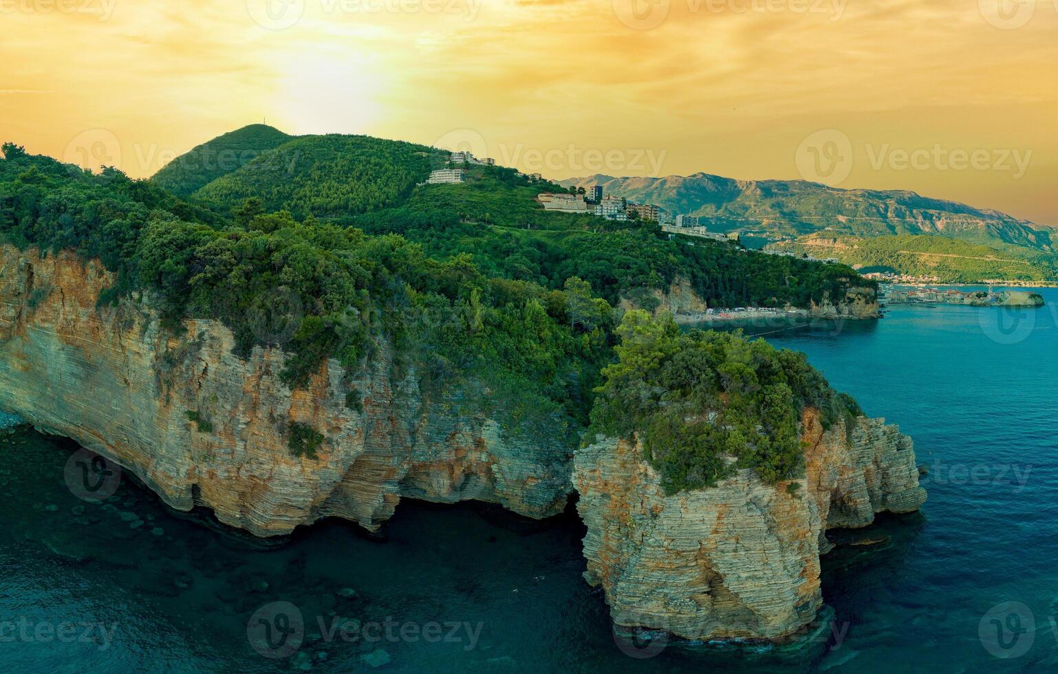 Panorama of cliff with wild vegetation above the waves of the Ad photo