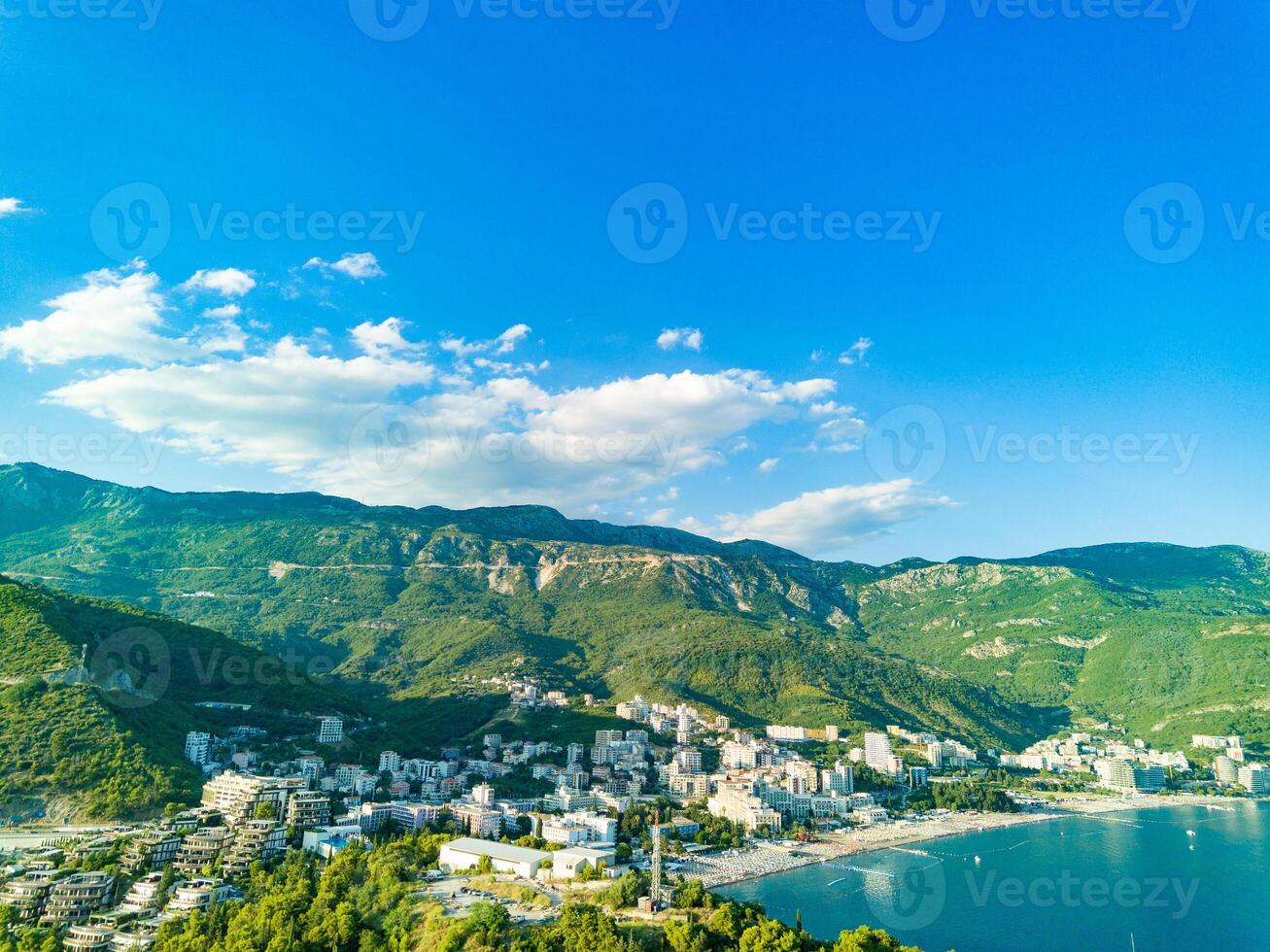 Birds eye view towns Budva Becici hotels beaches Adriatic Sea backdrop Montenegrin Mountains photo