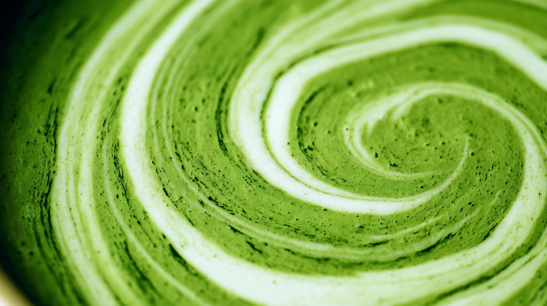 Swirling Green Matcha Latte Art Close Up with Creamy Foam Texture. photo