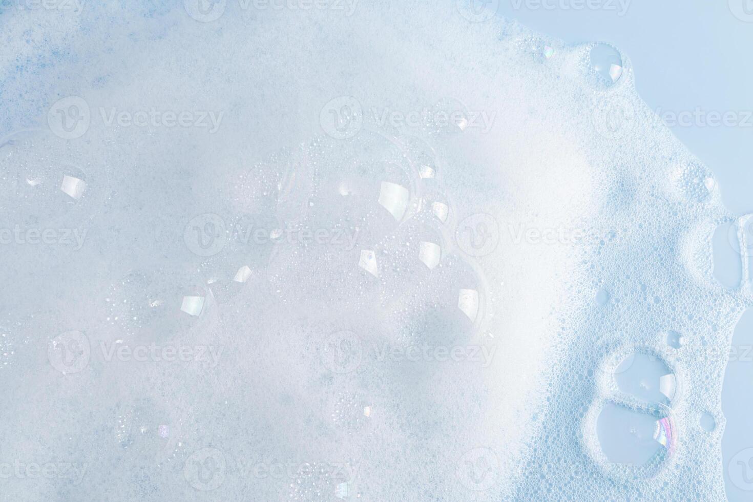 large transparent bubbles on the foam surface of detergent or cosmetics. white foam surface. texture. photo