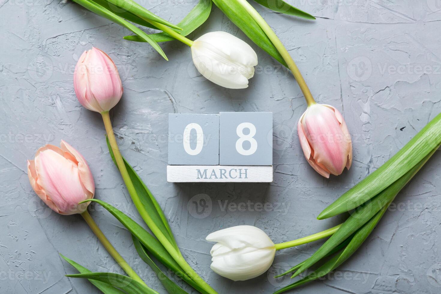 International Women's Day. greeting card design with tulips and calendar top view, with copy space photo