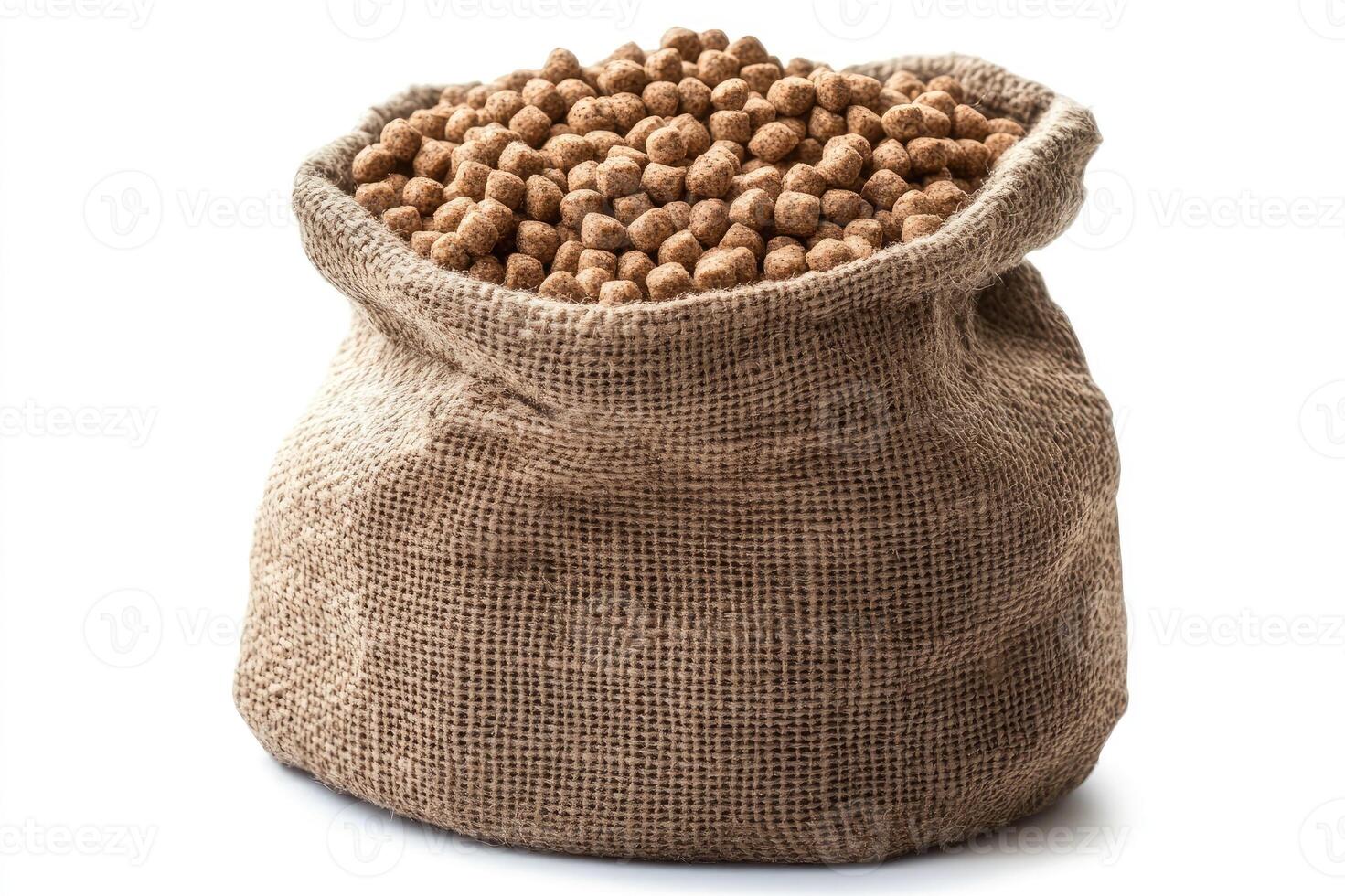 Burlap sack overflowing with dry pet food pellets on white background photo