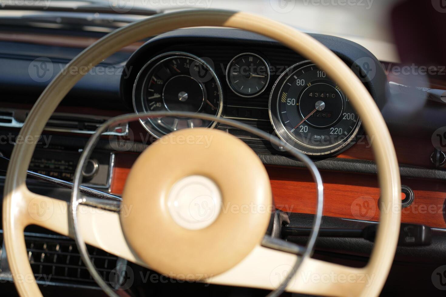 Vintage Classic car steering wheel, with chrome and leather textures in sharp detail, showcases the quality and precision of automotive craftsmanship under natural light.ec photo