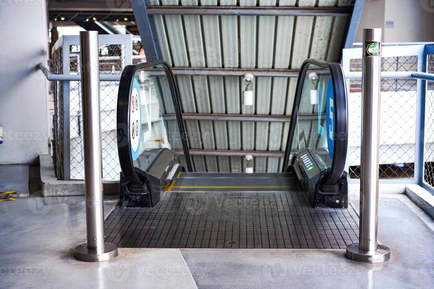 LED green light arrow Signage stainless pole in front of escalator sign the passenger the right way up and down.aa photo