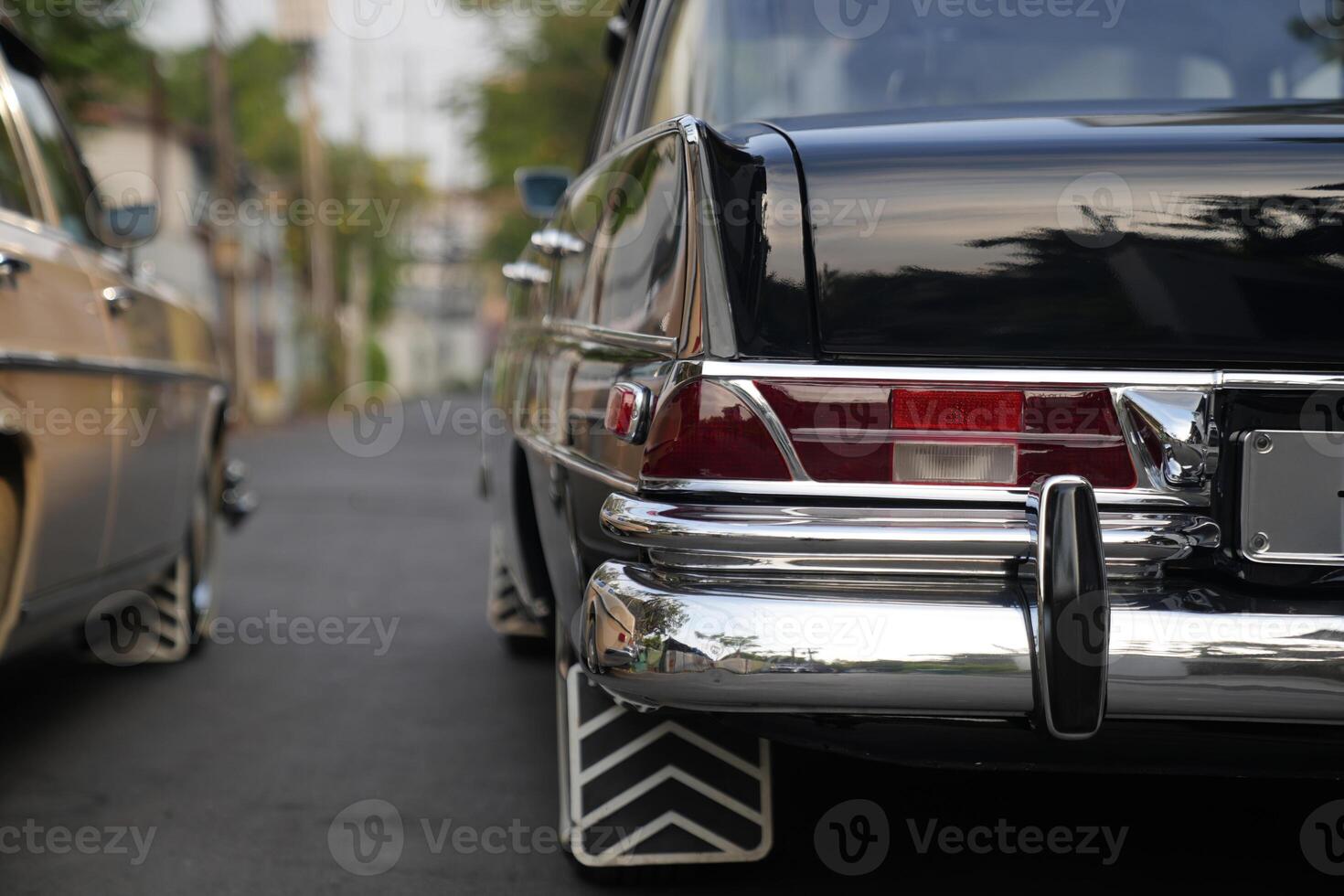 The tail lights, turn signals, and chrome accents on the rear of classic cars exude vintage charm and sophisticated design.b photo