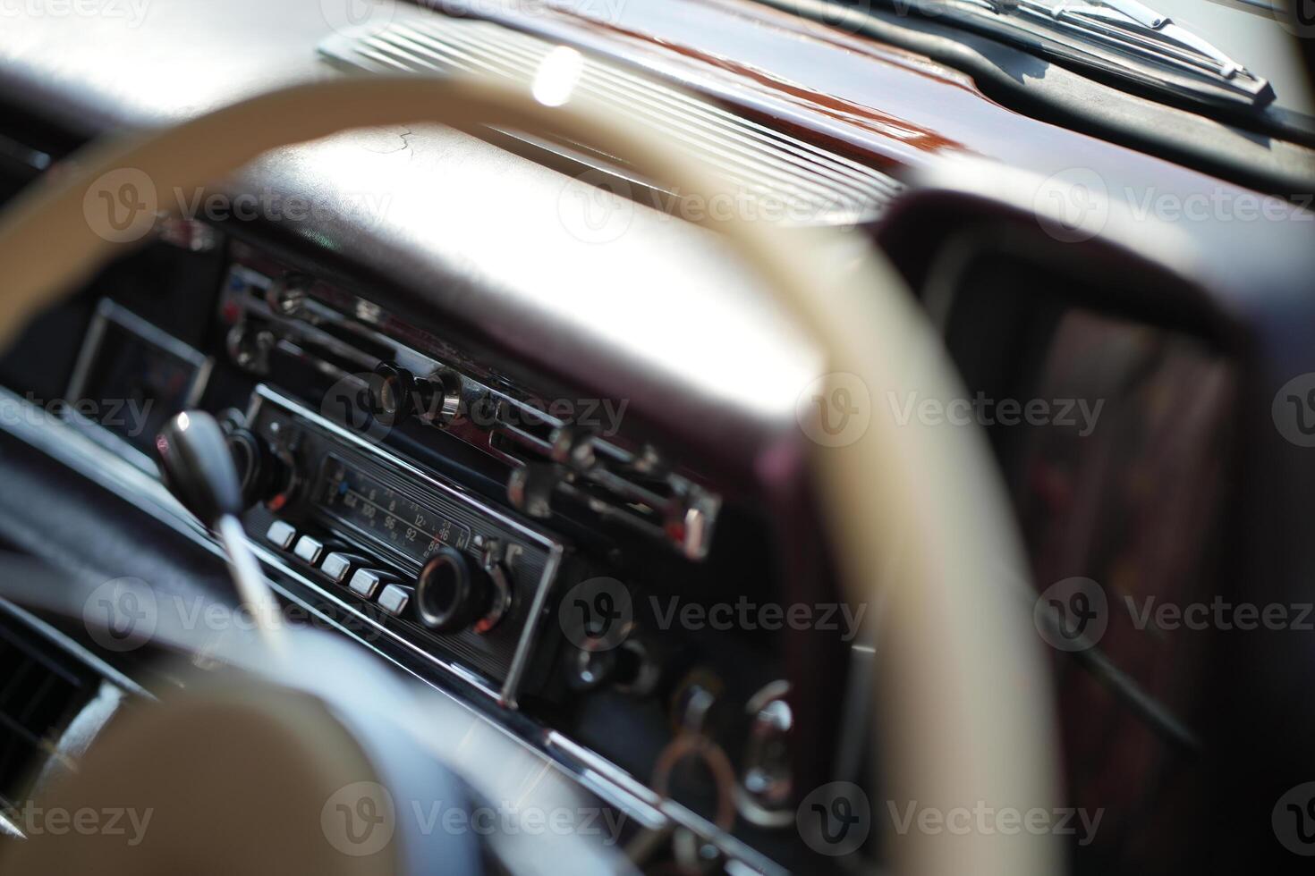 The dashboard of a vintage classic car features detailed analog gauges, a radio, and air vents in polished wood and chrome, offering a fresh yet luxurious look.eg photo