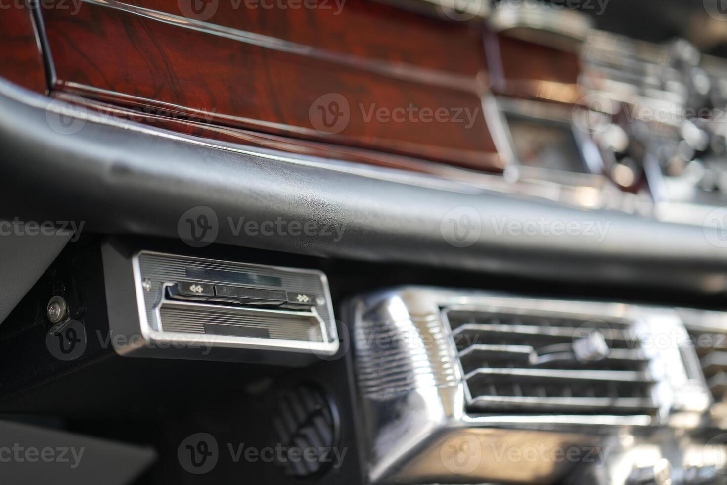 The dashboard of a vintage classic car features detailed analog gauges, a radio, and air vents in polished wood and chrome, offering a fresh yet luxurious look.df photo