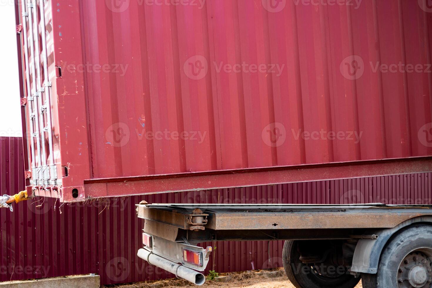 Transportation of cargo container. Removing container from trailer platform photo