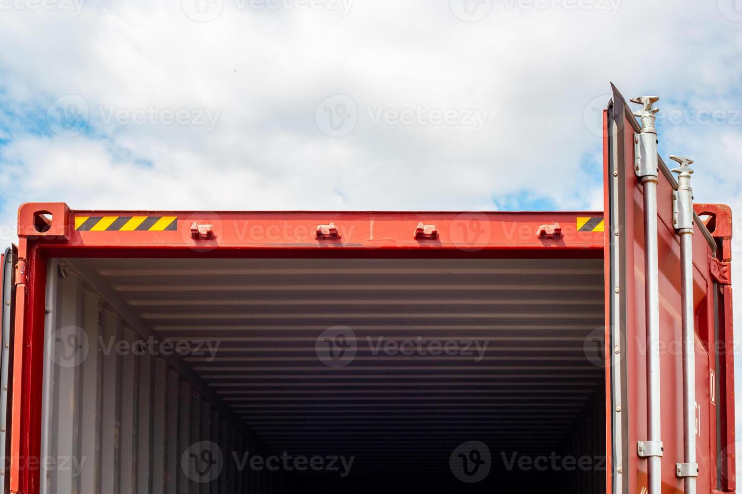 Open red cargo container with empty interior against sky background, transportation and storage photo