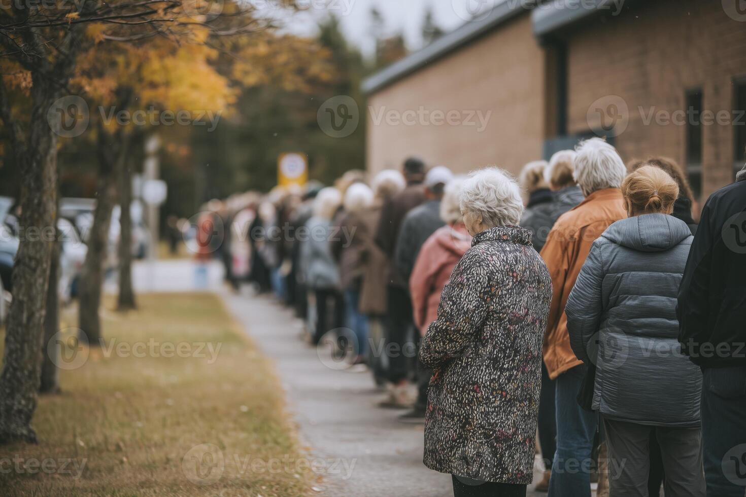 Line of people waiting outdoors in an autumn setting photo
