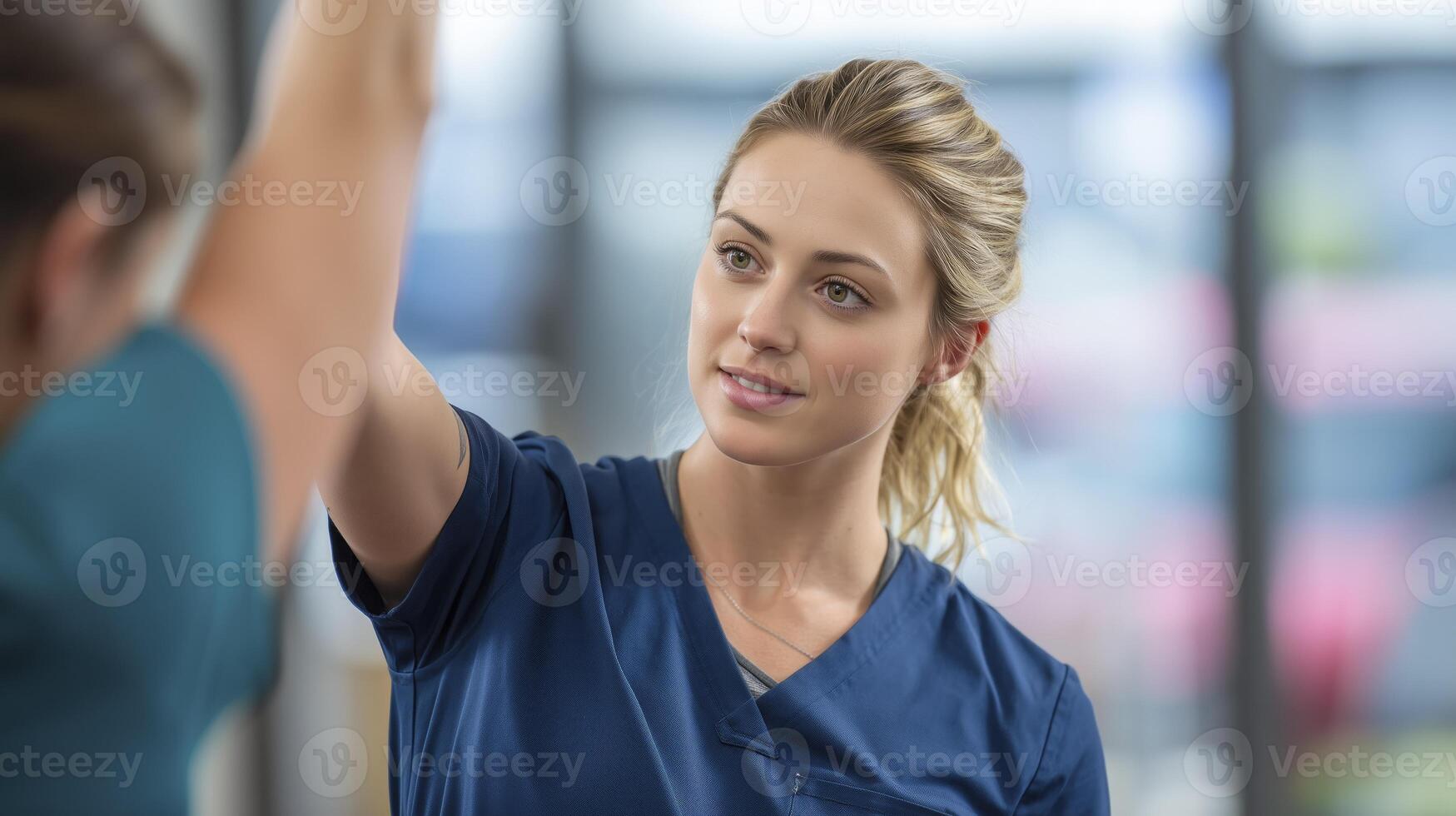 Physical therapist helping a patient with arm exercises photo