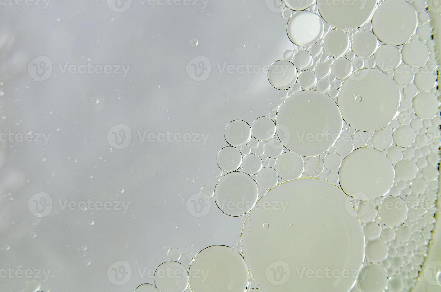 Top view of close up of oil swirling on water. Oil and water mixture concept photo