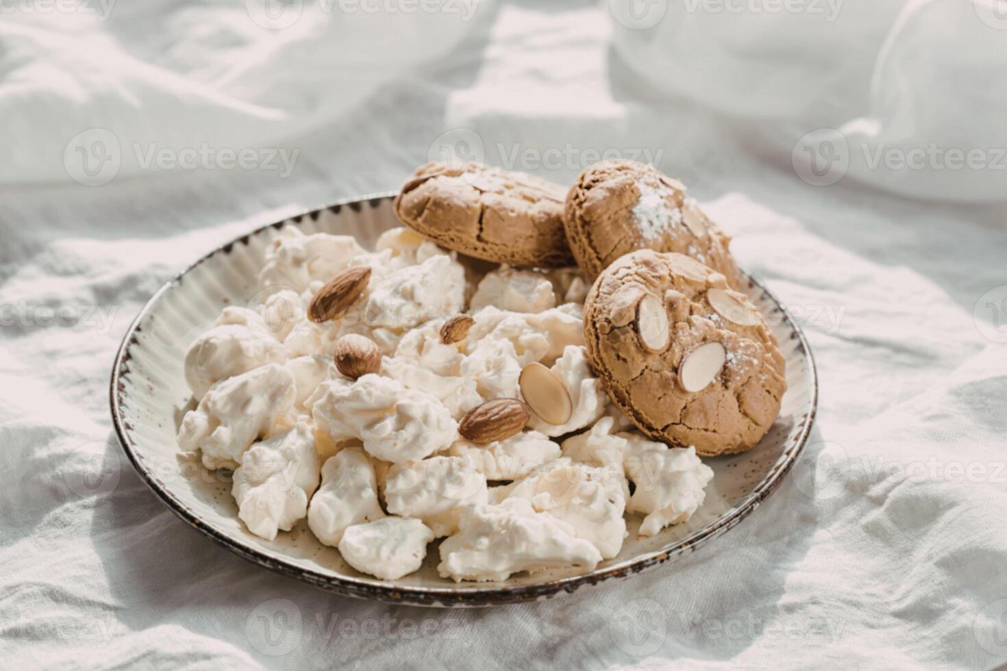 Popcorn with almond cookies on a plate photo