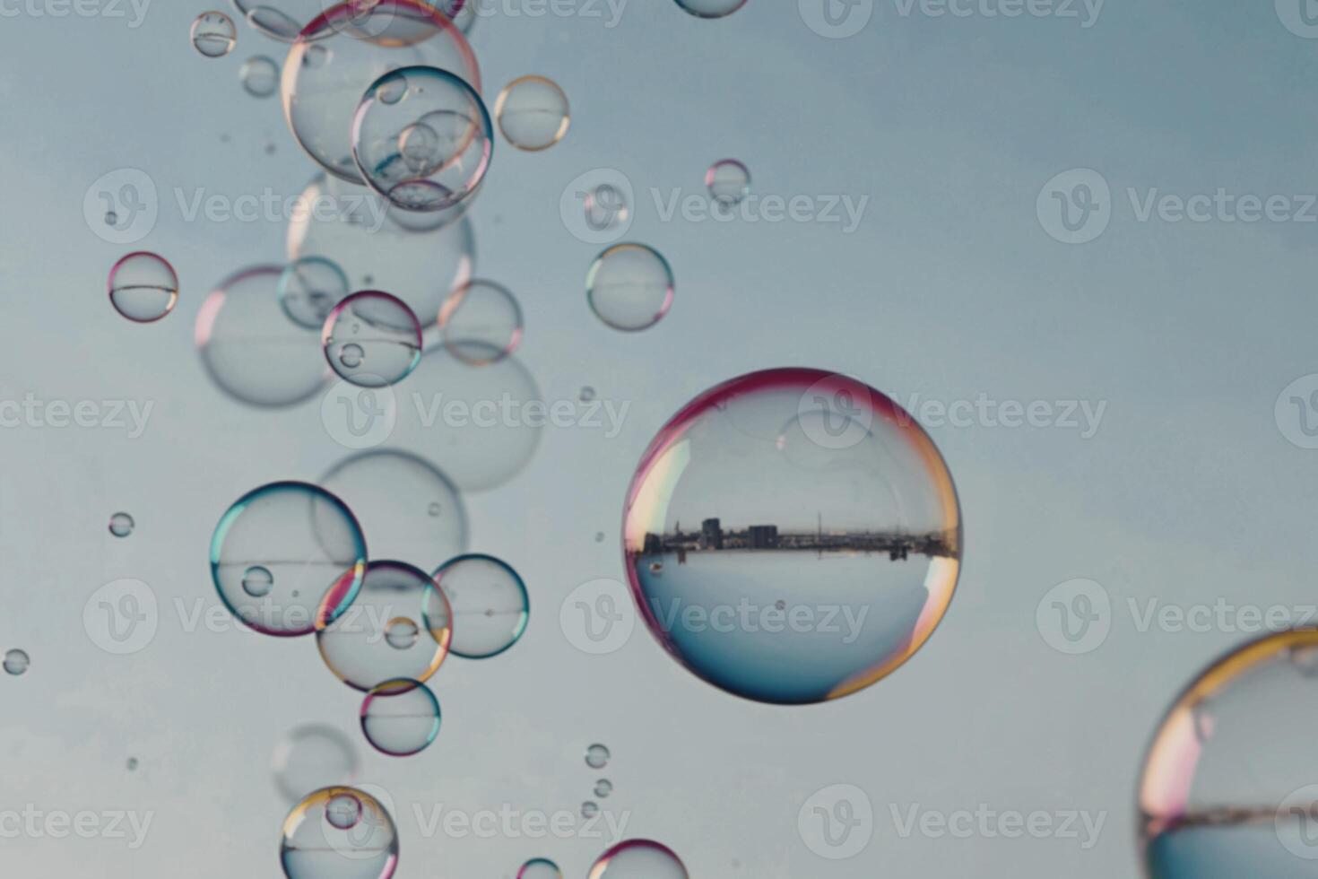 Bubbles floating in the air with a blue sky photo