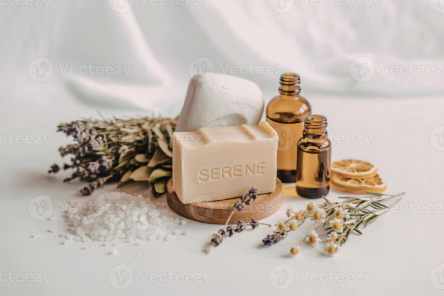 A bottle of soap, a bottle of essential oils and a bunch of lavender photo