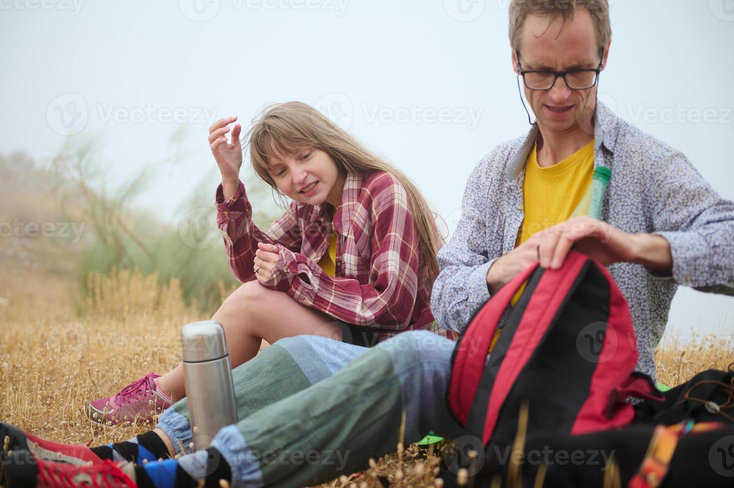 Two Friends Enjoying a Relaxing Hiking Break in the Scenic Outdoors photo