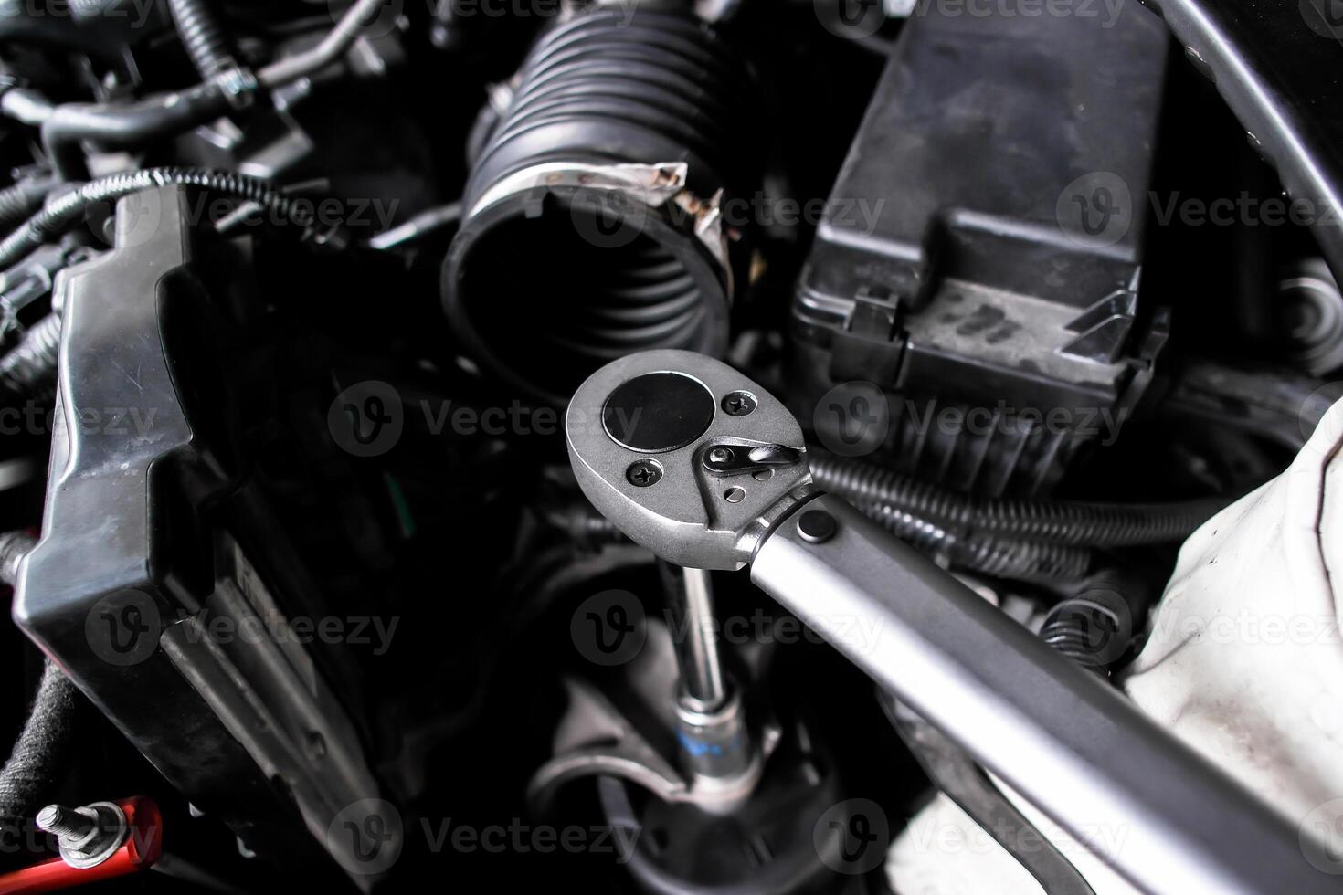 Torque wrench in use, auto repair or car maintenance and engine work with mechanic tool, automotive service. photo
