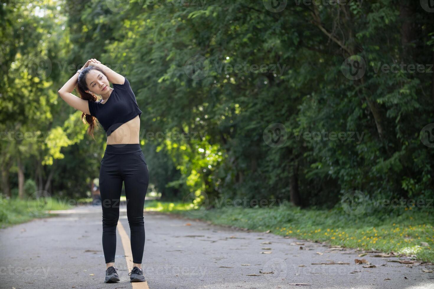 Portrait of beautiful female runner wearing workout clothe and warm up her body get ready for jogging in morning get good health. female runner warm up her body alone get ready for jogging in park. photo