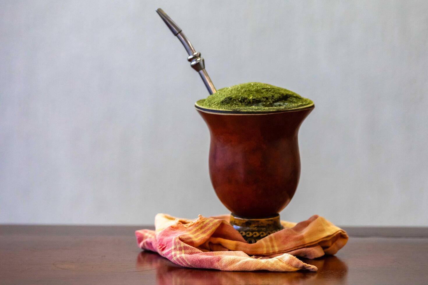 Traditional chimarrao served in a gourd and with araucaria pine nuts isolated photo