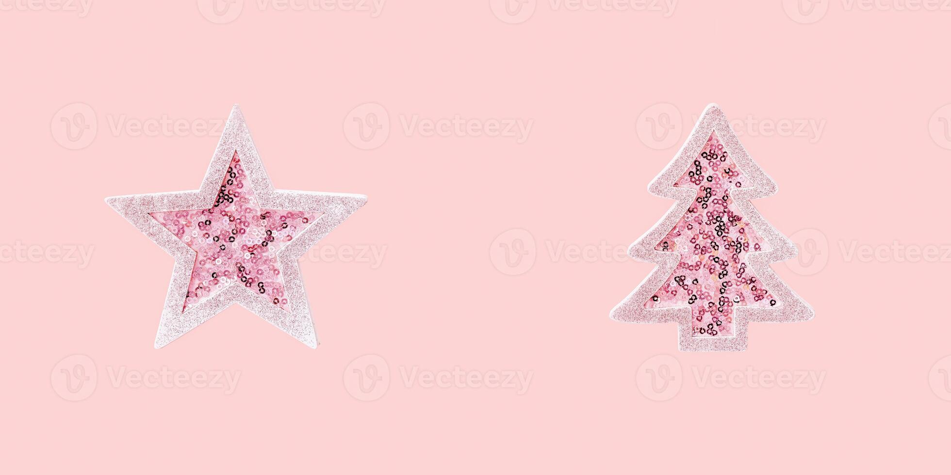 Minimal Merry Christmas and Happy New Year greeting card with pink toy Christmas tree and star with shiny sequins photo