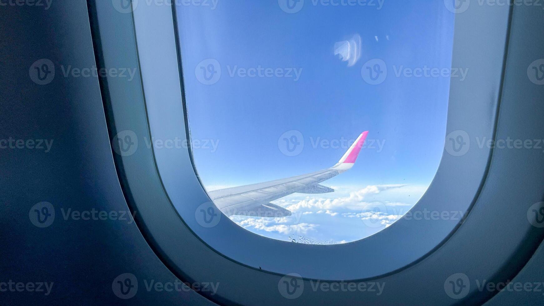 Aerial vista through airplane window, serene sky journey, cloud soaring dreams, perfect for World Tourism Day or Aviation Heritage photo