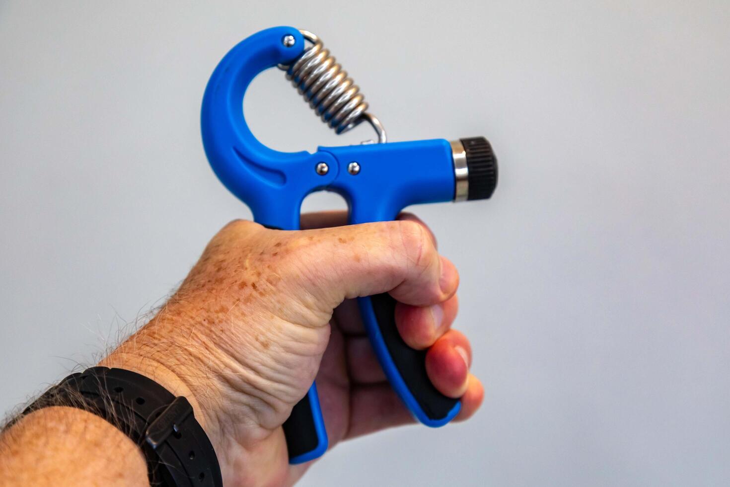 Blue hand grippers for strength training and exercise photo