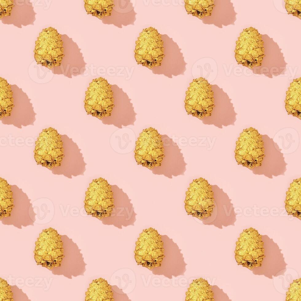 Natural pine cones golden colored as New Year pattern. Bright Christmas holidays decor photo