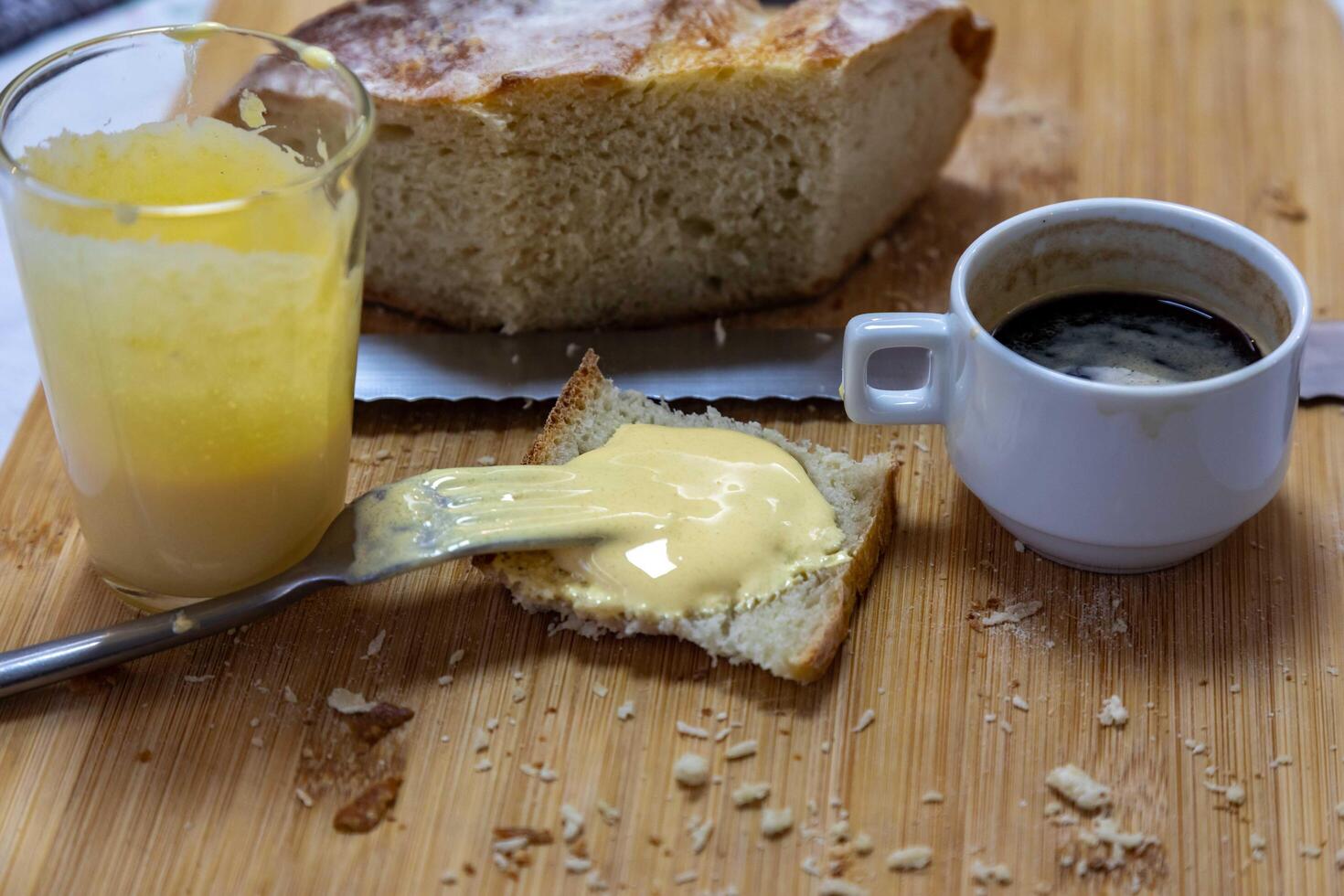 The iconic and traditional eggnog with free-range egg yolk and sugar. Rustic bread with eggnog and coffee, real food photo