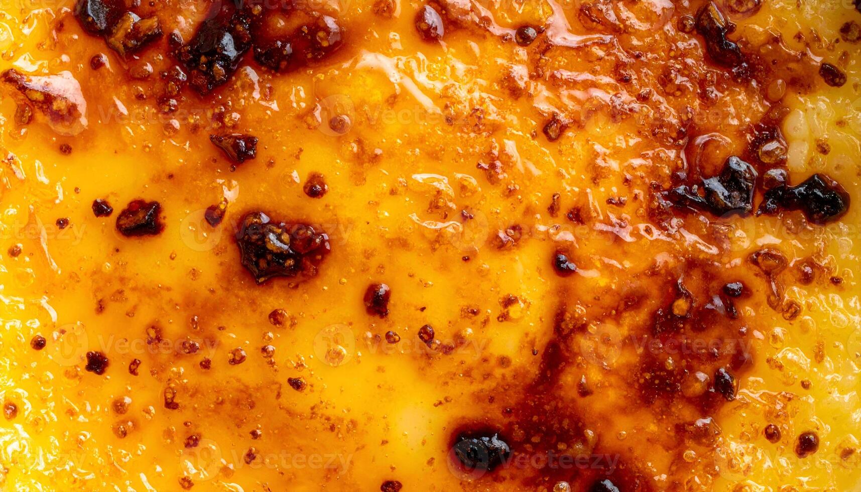 burnt caramel surface in extreme macro view, glossy and textured sugar crust on creamy dessert for culinary design and food photography photo