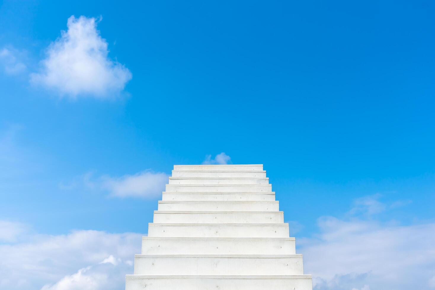 White infinite stair leading up into the blue sky. Concept of motivation, self-development, hope and business opportunity. photo