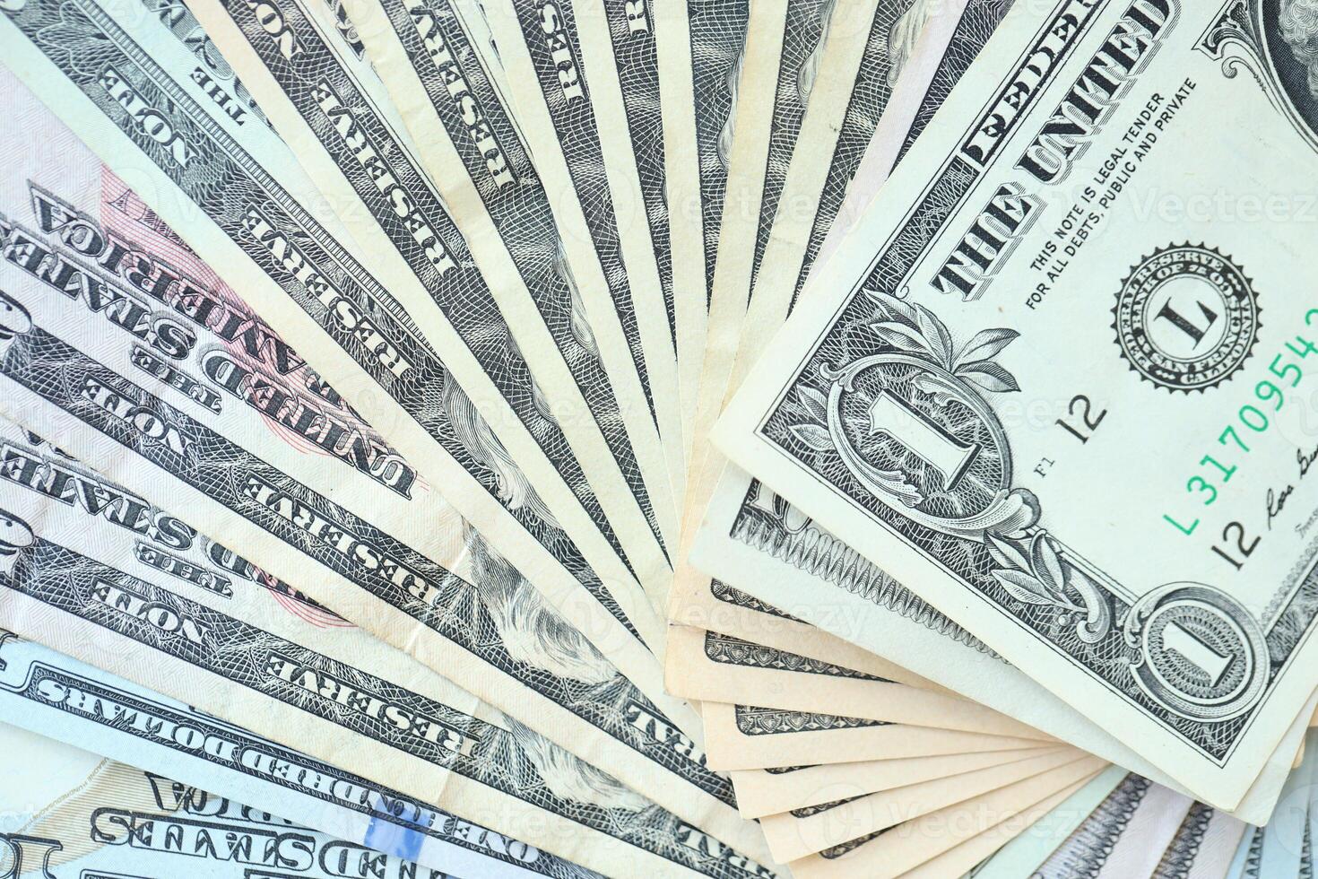 Many dollar bills with nominations lies in big pile photo