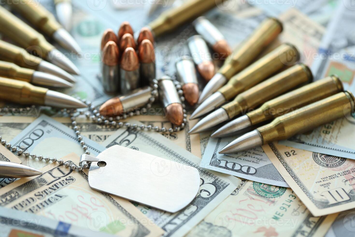 The medallion of a soldier and cartridges lies on dollar bills photo