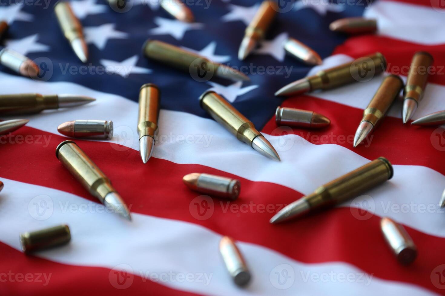 Bullets with USA flag in light. Patriotic background image with ammo and United States flag photo