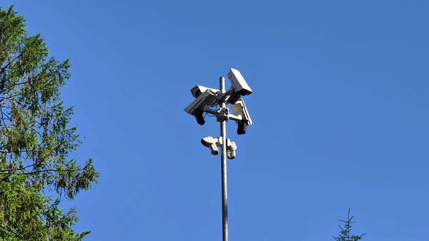 Surveillance Cameras Installed on a Pole Beneath a Clear and Blue Sky That Looks Stunning photo
