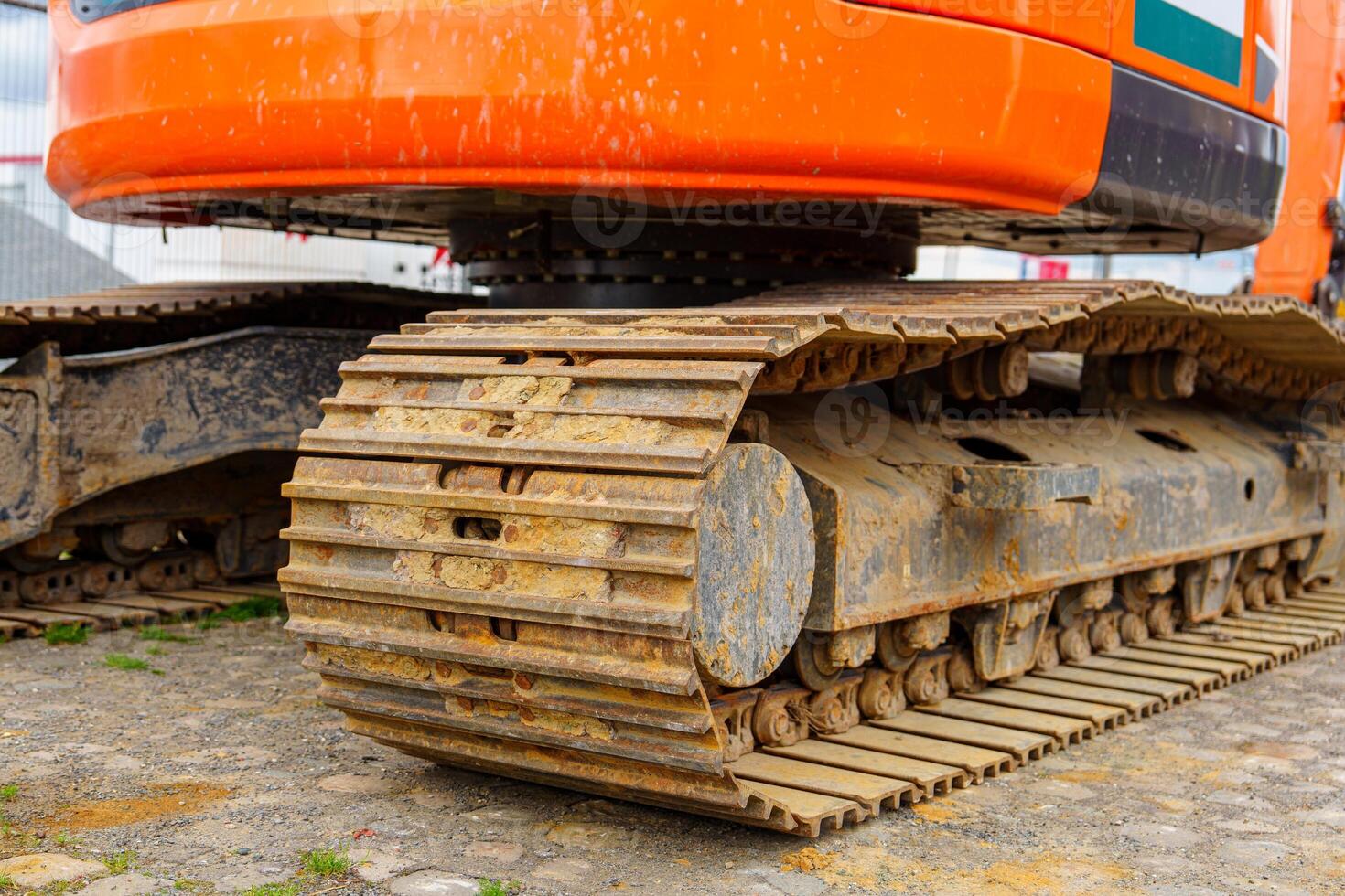 A close-up shot of heavy construction equipment tracks. Ideal for illustrating construction and engineering, this image conveys power, durability, and reliability in industrial projects. photo