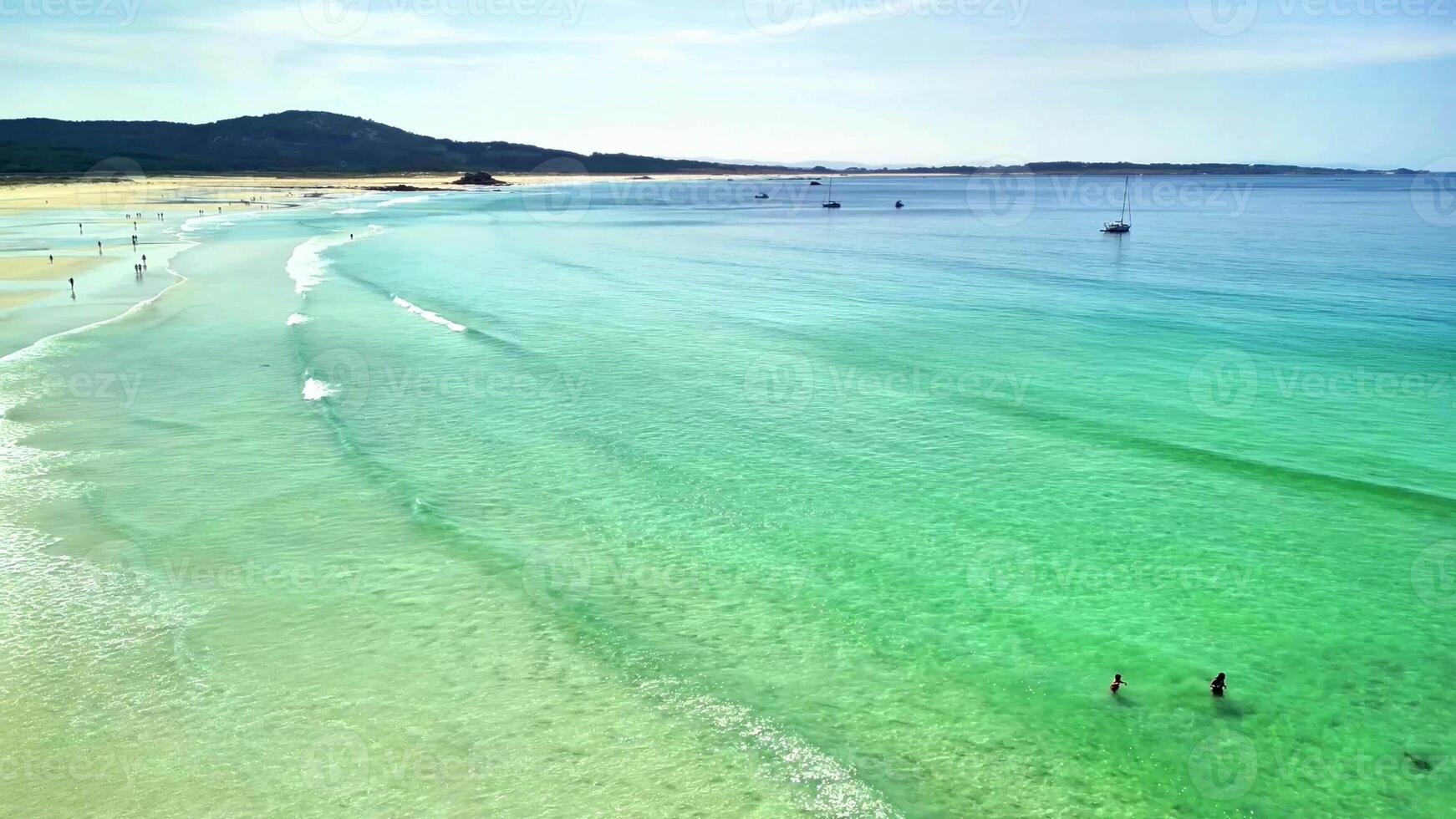A beautiful beach with turquoise waters and soft, golden sands, ideal for relaxation and leisure activities photo